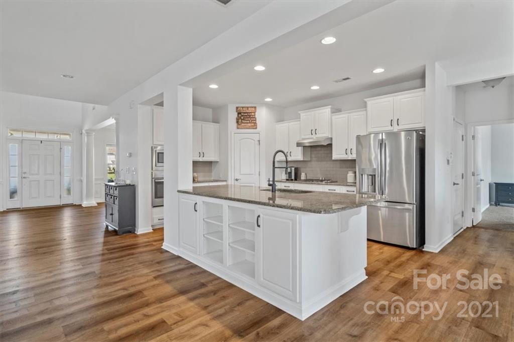 86646 Arrington Road Lancaster, SC 29720 - Photo 15 of 42 a kitchen with stainless steel appliances granite countertop a refrigerator a sink a stove and a wooden cabinets