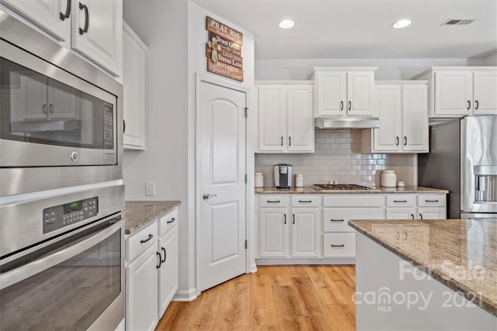 86646 Arrington Road Lancaster, SC 29720 - Photo 17 of 42 a kitchen with stainless steel appliances granite countertop a stove a sink and a refrigerator