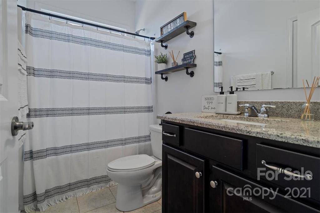 86646 Arrington Road Lancaster, SC 29720 - Photo 22 of 42 a bathroom with a granite countertop shower sink vanity and toilet