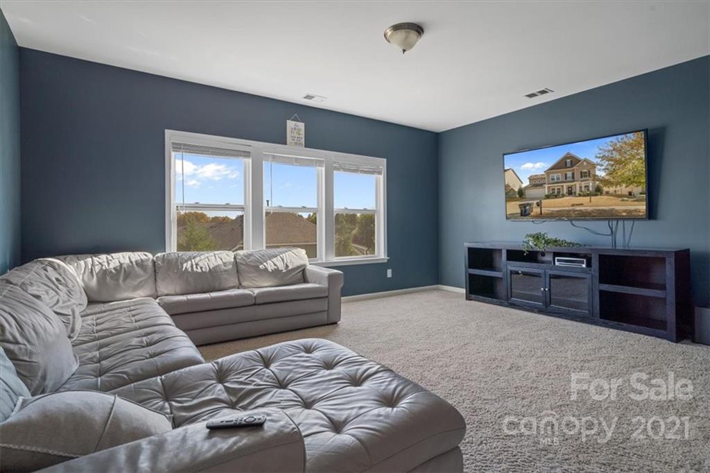 86646 Arrington Road Lancaster, SC 29720 - Photo 29 of 42 a living room with furniture and a flat screen tv