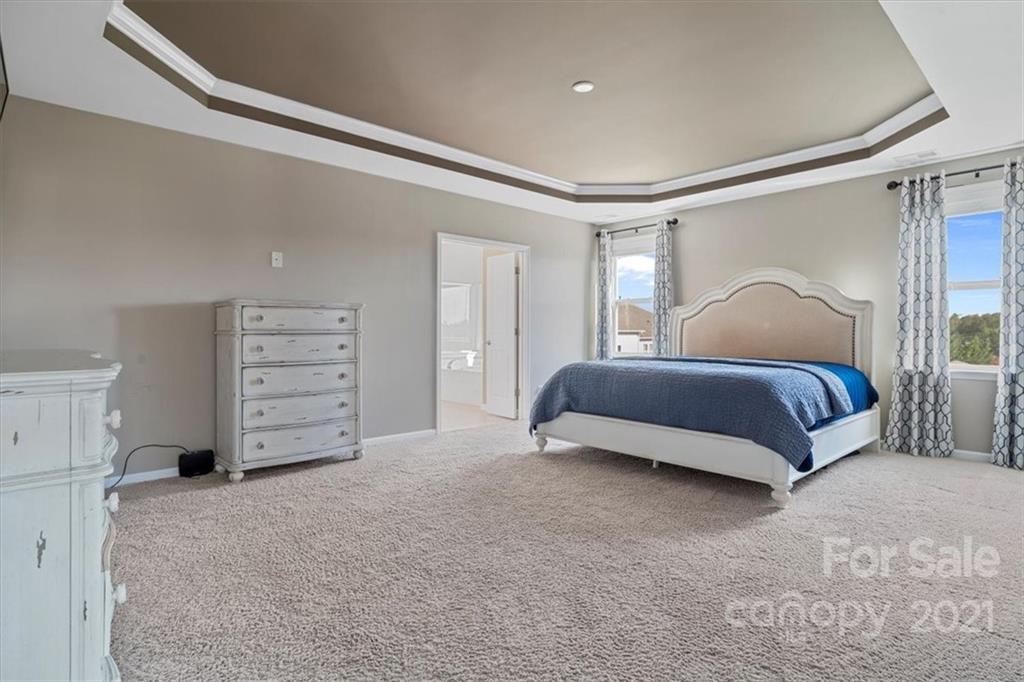 86646 Arrington Road Lancaster, SC 29720 - Photo 30 of 42 a spacious bedroom with a bed and cabinet
