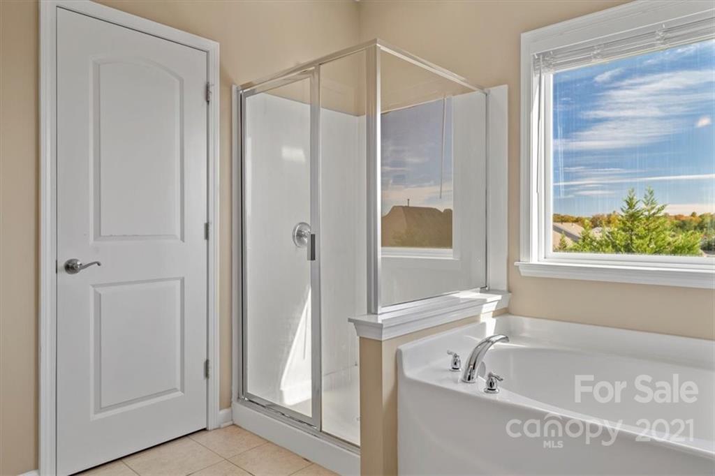86646 Arrington Road Lancaster, SC 29720 - Photo 32 of 42 a bathroom with a tub and a shower