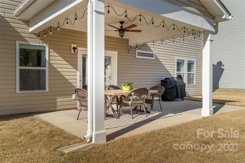 86646 Arrington Road Lancaster, SC 29720 - Photo 37 of 42 a view of a patio with table and chairs and wooden fence
