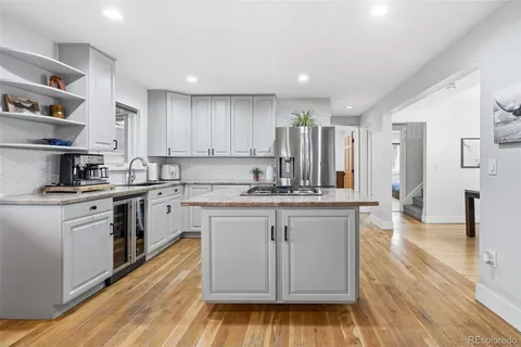 a kitchen with stainless steel appliances granite countertop a stove a sink dishwasher and a refrigerator