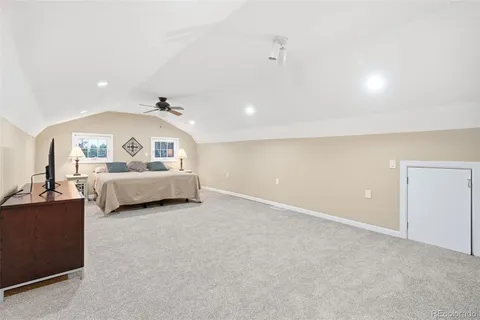 a bedroom with a large bed and a chandelier