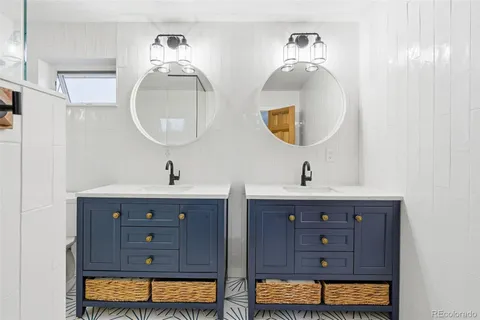 a bathroom with a double vanity sink and a mirror