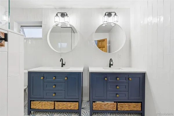 a bathroom with a double vanity sink and a mirror