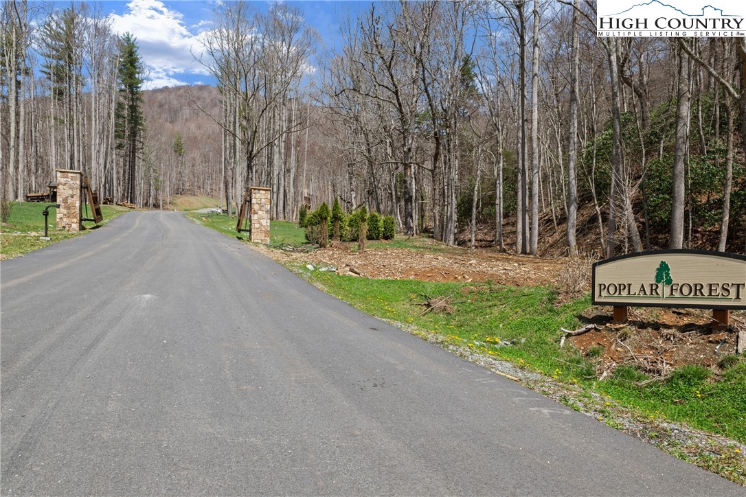 Lot 36 Poplar Forest Drive Boone, NC 28607 - Photo 2 of 21 a front view of a house with a yard and trees