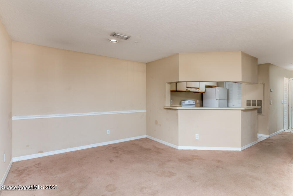 7667 North Wickham Road, Unit 312 Melbourne, FL 32940 - Photo 16 of 47 a view of cabinets and wooden floor