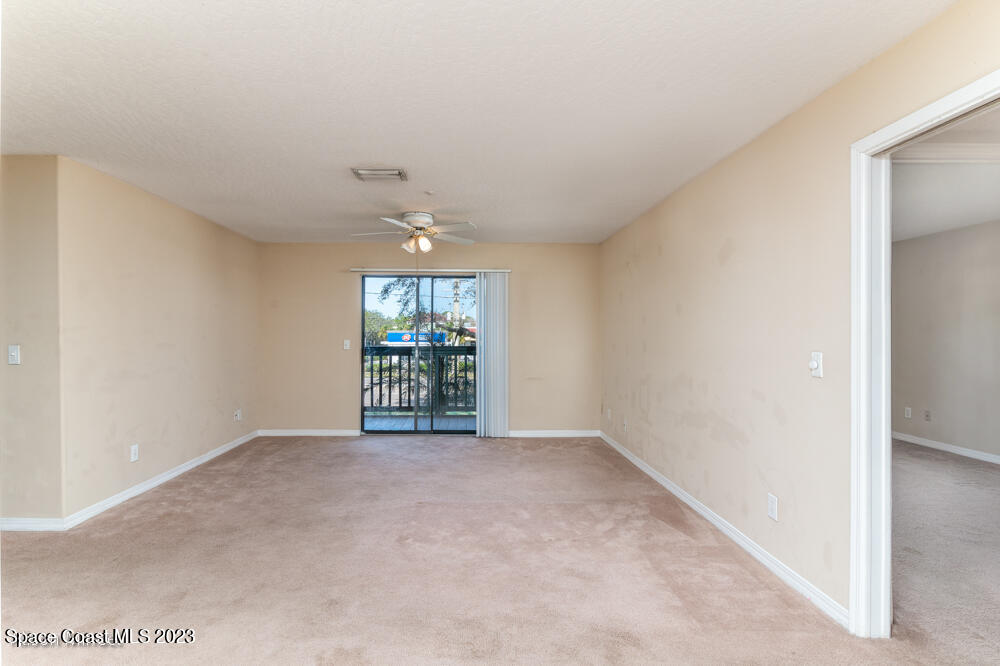 7667 North Wickham Road, Unit 312 Melbourne, FL 32940 - Photo 17 of 47 an empty room with windows and ceiling fan