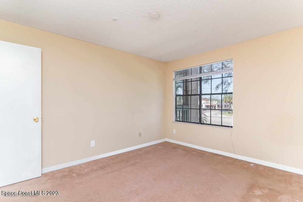 7667 North Wickham Road, Unit 312 Melbourne, FL 32940 - Photo 21 of 47 an empty room with windows