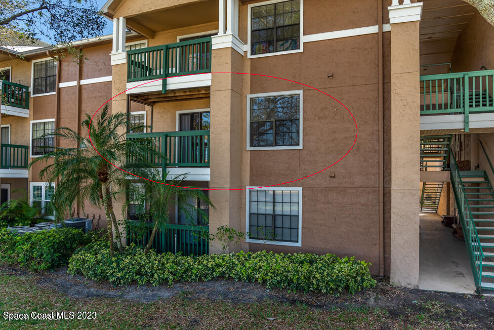 7667 North Wickham Road, Unit 312 Melbourne, FL 32940 - Photo 33 of 47 front view of a brick house with a small yard