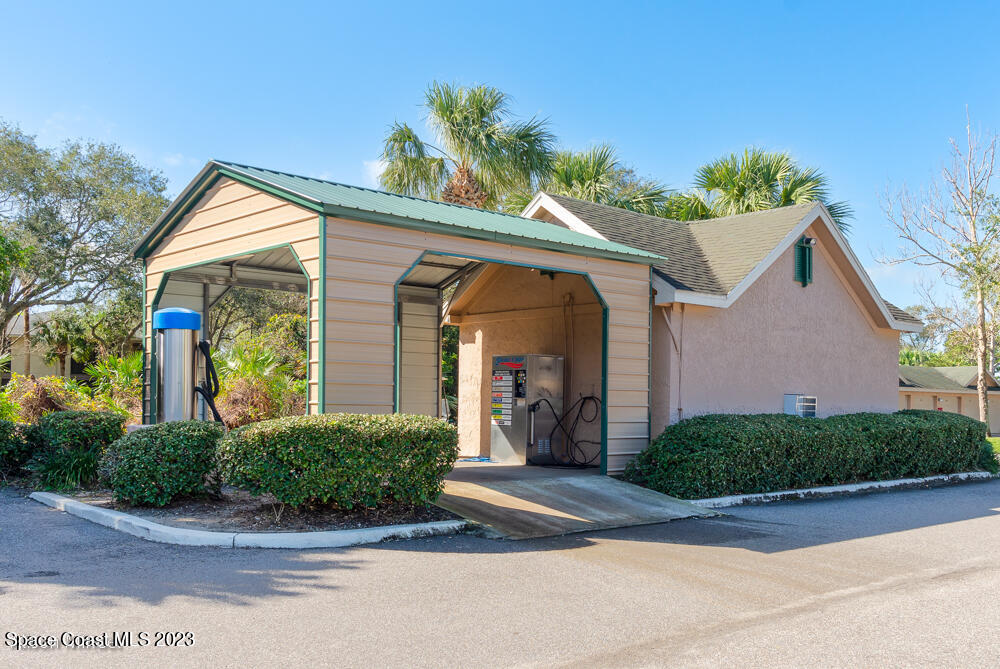 7667 North Wickham Road, Unit 312 Melbourne, FL 32940 - Photo 46 of 47 a front view of a house with a yard
