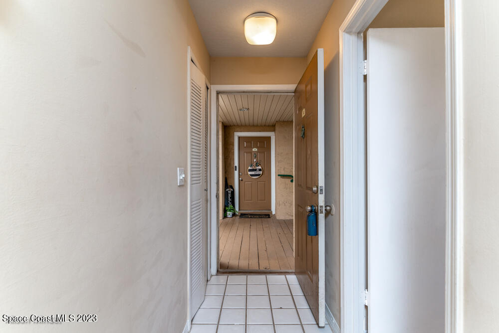 7667 North Wickham Road, Unit 312 Melbourne, FL 32940 - Photo 8 of 47 a view of a hallway with wooden floor and a bathroom
