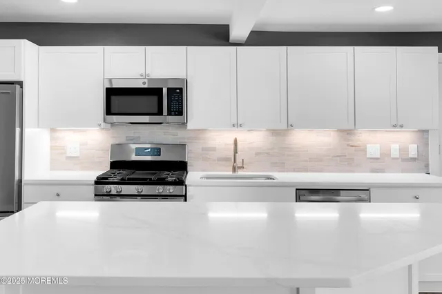 a room with a sink and large window