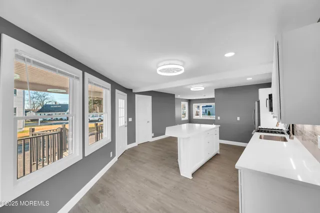 a kitchen with granite countertop a refrigerator stove and microwave