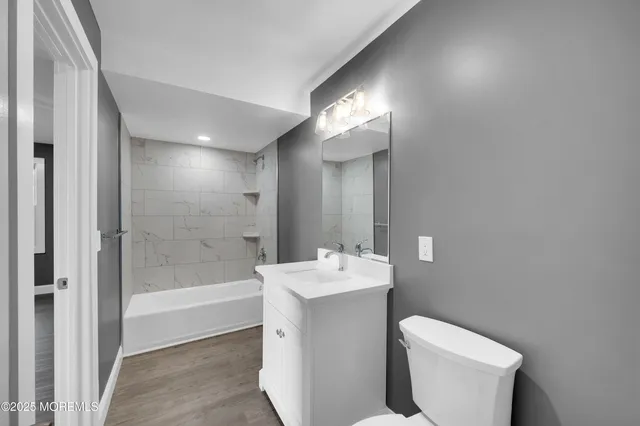 an empty room with wooden floor and a window