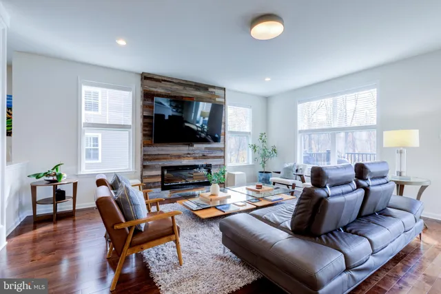 a view of a roof deck with table and chairs with wooden floor and fence