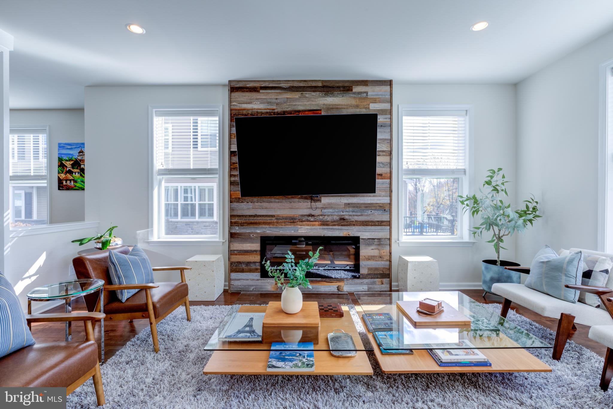 3044 Marias Way Garnet Valley, PA 19060 - Photo 18 of 63 a living room with furniture a flat screen tv and a fireplace