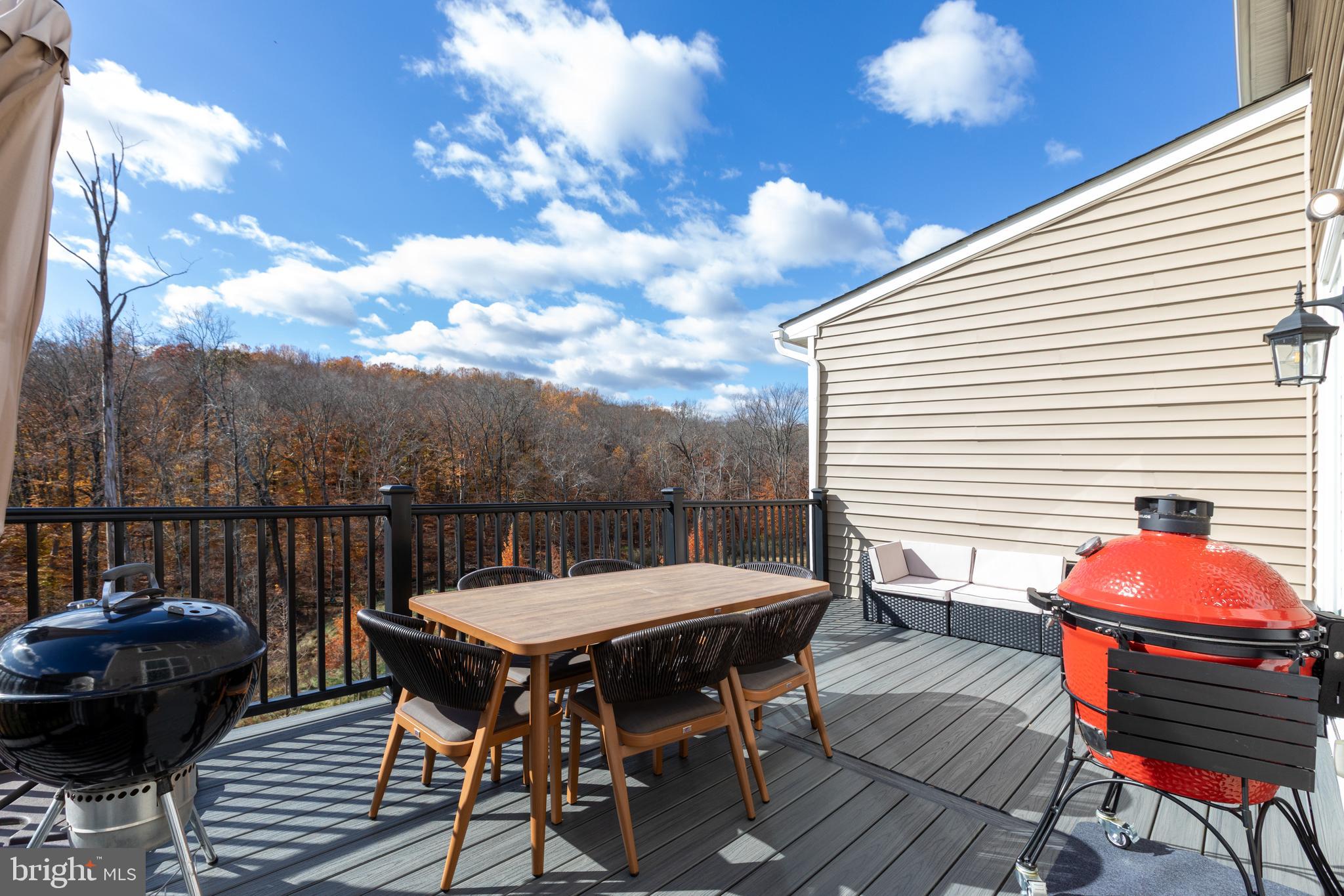 3044 Marias Way Garnet Valley, PA 19060 - Photo 21 of 63 a view of a roof deck with table and chairs with wooden floor and fence