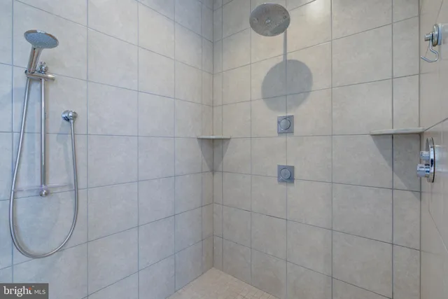 a spacious bedroom with a bed and a chandelier