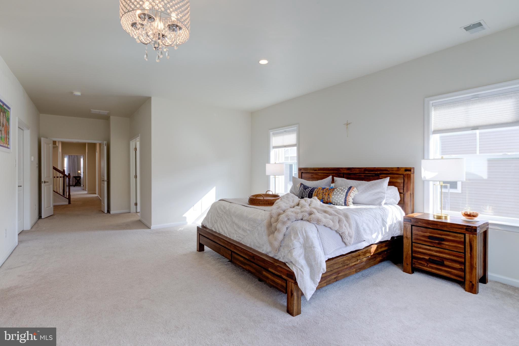 3044 Marias Way Garnet Valley, PA 19060 - Photo 35 of 63 a spacious bedroom with a bed and a chandelier