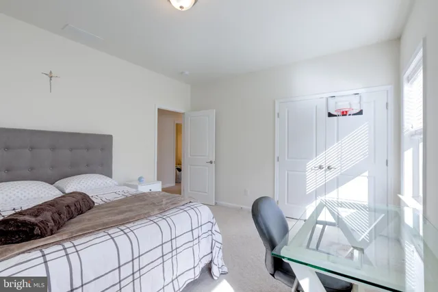 a living room with furniture and a book shelf