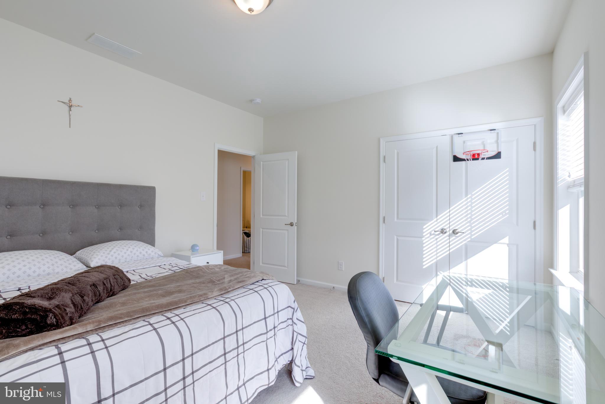 3044 Marias Way Garnet Valley, PA 19060 - Photo 40 of 63 a bedroom with a bed a chair and potted plant with the wooden floor