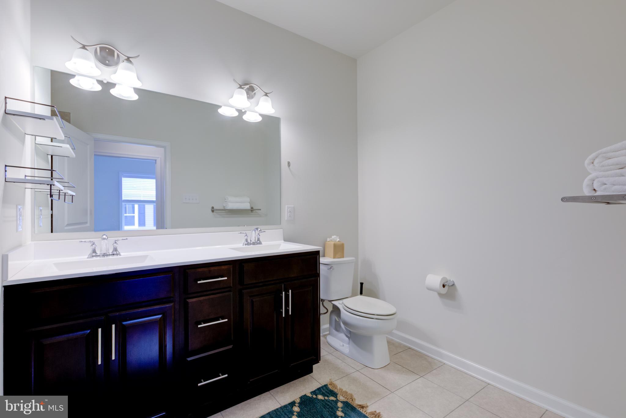 3044 Marias Way Garnet Valley, PA 19060 - Photo 44 of 63 a bathroom with a toilet a sink and mirror