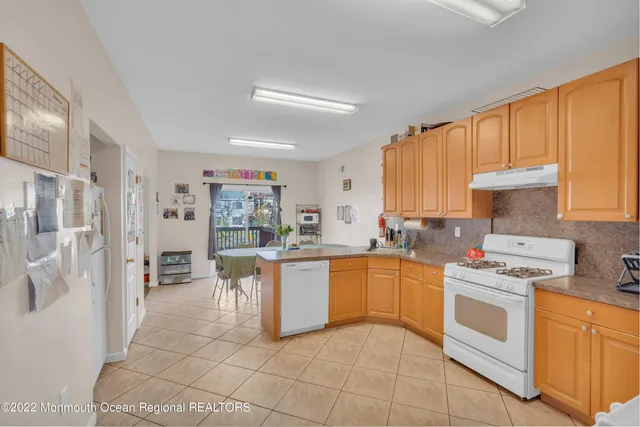 a kitchen with stainless steel appliances a refrigerator and cabinets