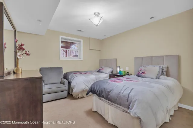 a spacious bathroom with a granite countertop sink a mirror and a bathtub