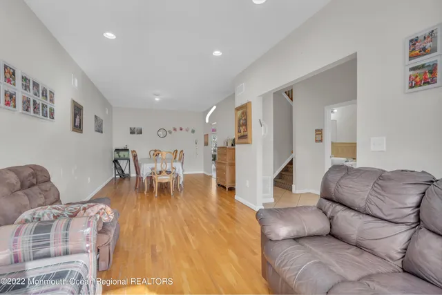 a living room with furniture and a dining table