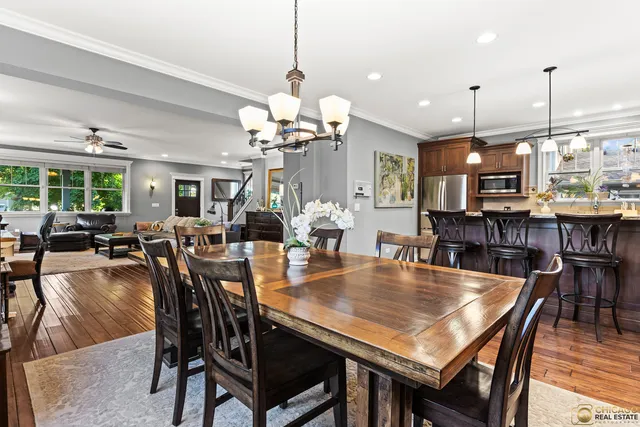 a dining room filled with lots of furniture and a chandelier