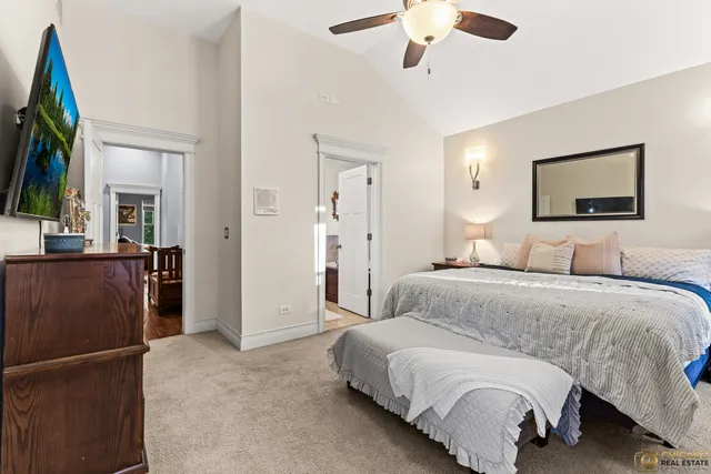 a spacious bedroom with a bed and a chandelier
