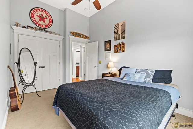 a bedroom with a bed and a painting on the wall