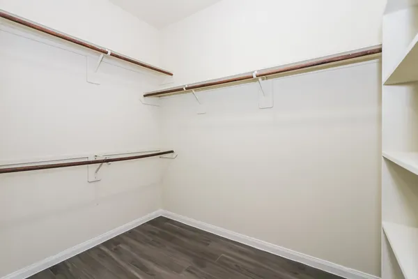 a view of small space with racks on the wall and a window