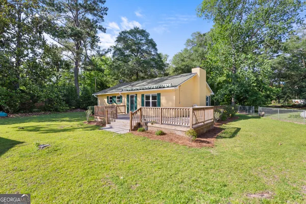 a view of a house with backyard and a small cabin