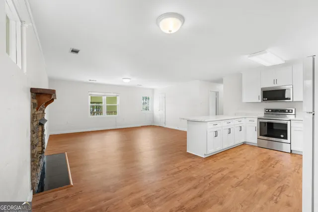 a view of a kitchen with microwave and stove