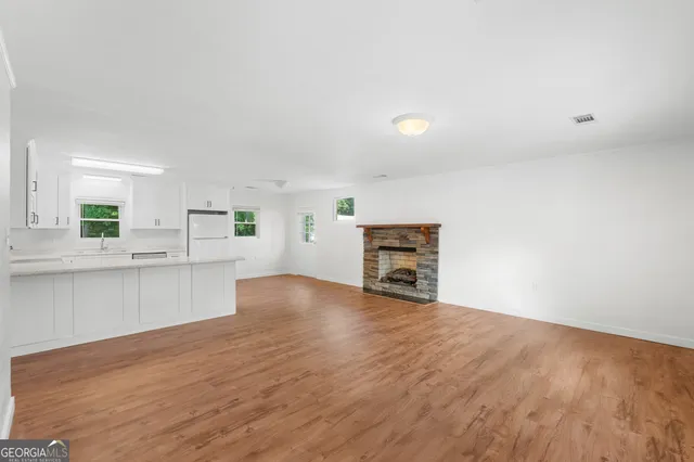 a view of kitchen with wooden floor and electronic appliances