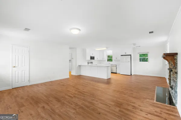 a view of a kitchen with microwave and cabinets