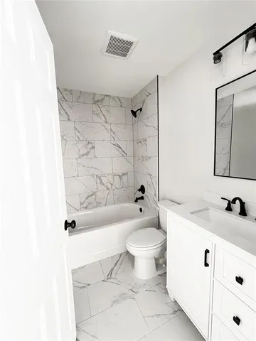 a bathroom with a sink toilet a mirror and shower