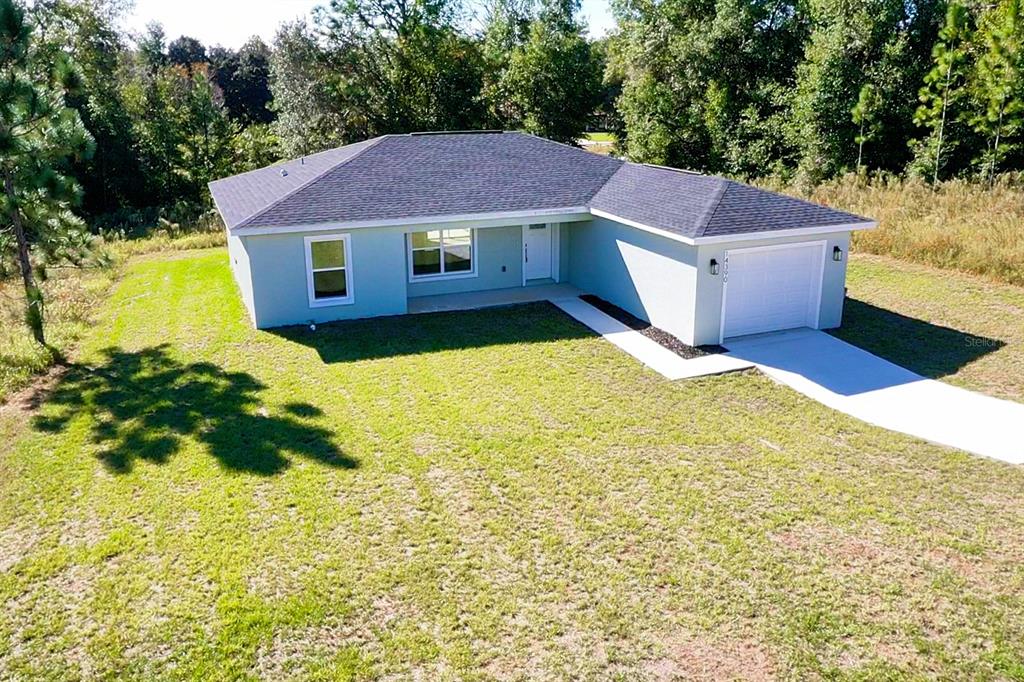 14390 Southwest 30th Place Ocala, FL 34481 - Photo 3 of 16 a house view with a swimming pool