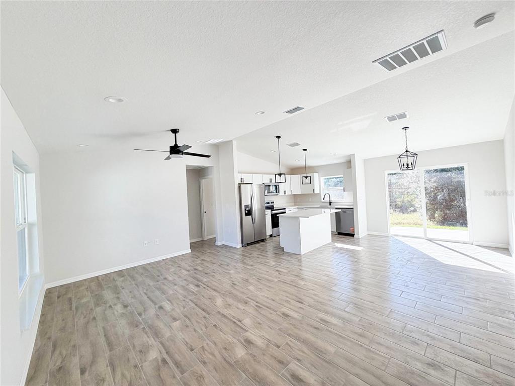 14390 Southwest 30th Place Ocala, FL 34481 - Photo 8 of 16 a view of a kitchen with a sink and dishwasher a refrigerator with wooden floor
