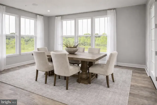 a large bed sitting in a bedroom next to a window and a chair