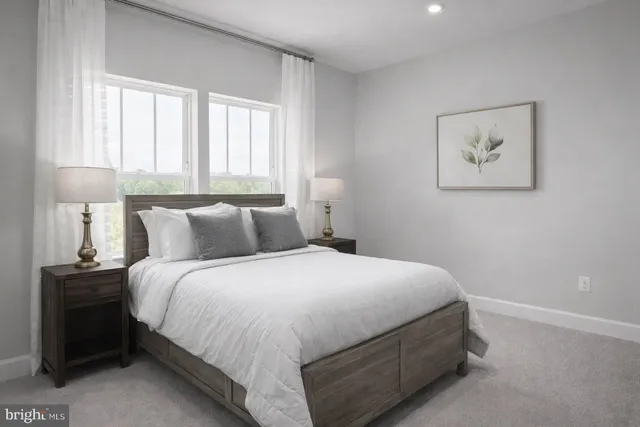 a large bed sitting in a bedroom next to a window