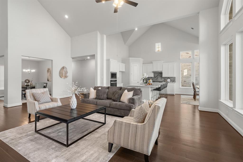 1320 Cartona Road Fate, TX 75087 - Photo 35 of 35 Soaring vaulted cathedral style ceilings, rich wood-finish flooring, abundant natural light, recessed lighting, and a kitchen featuring white cabinetry - Open Floor Plan