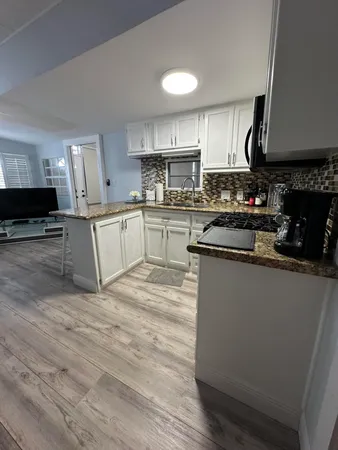 a kitchen with stainless steel appliances granite countertop a stove sink and cabinets