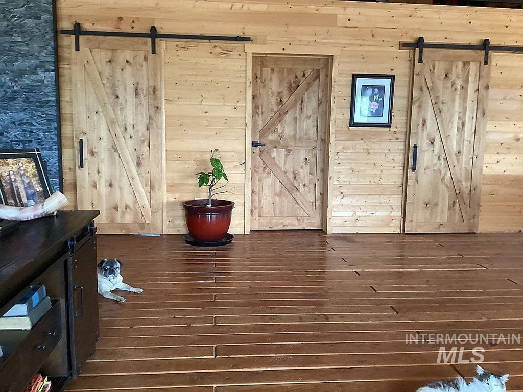 1000 Pardee Road Kamiah, ID 83536 - Photo 12 of 50 Wood-finish flooring spans the space, complemented by plank wood walls