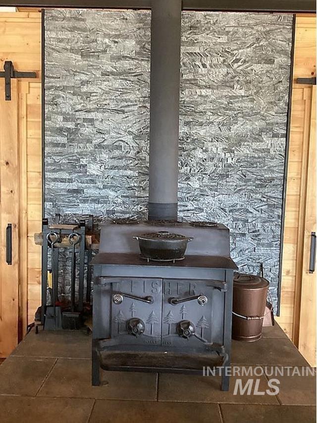 1000 Pardee Road Kamiah, ID 83536 - Photo 14 of 50 Freestanding wood-burning stove with a stone veneer accent wall