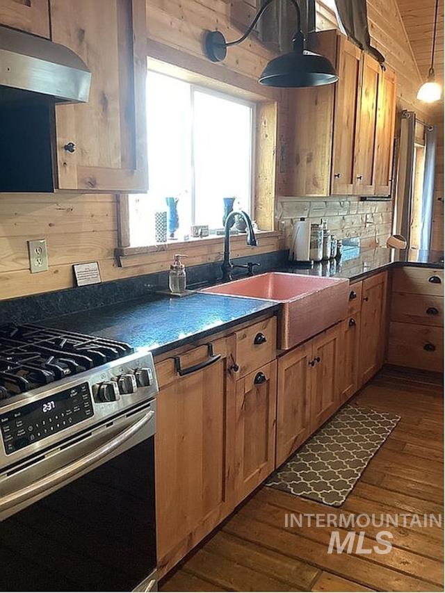 1000 Pardee Road Kamiah, ID 83536 - Photo 20 of 50 Kitchen featuring wood-paneled walls, wood-finish flooring, and natural wood cabinetry with dark hardware